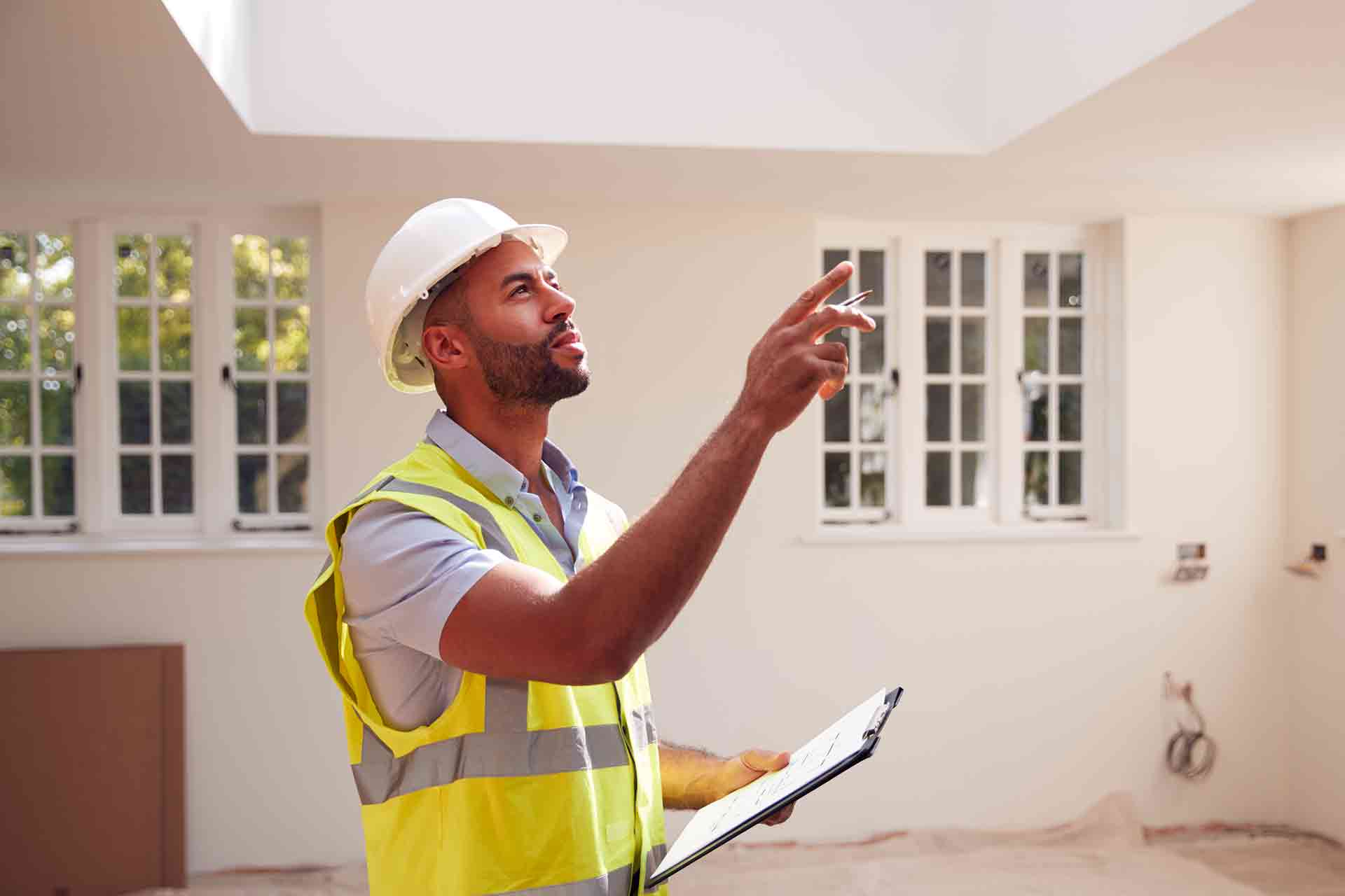 Third Party Wall Surveyors Huddersfield reviewing plans between two parties during a dispute